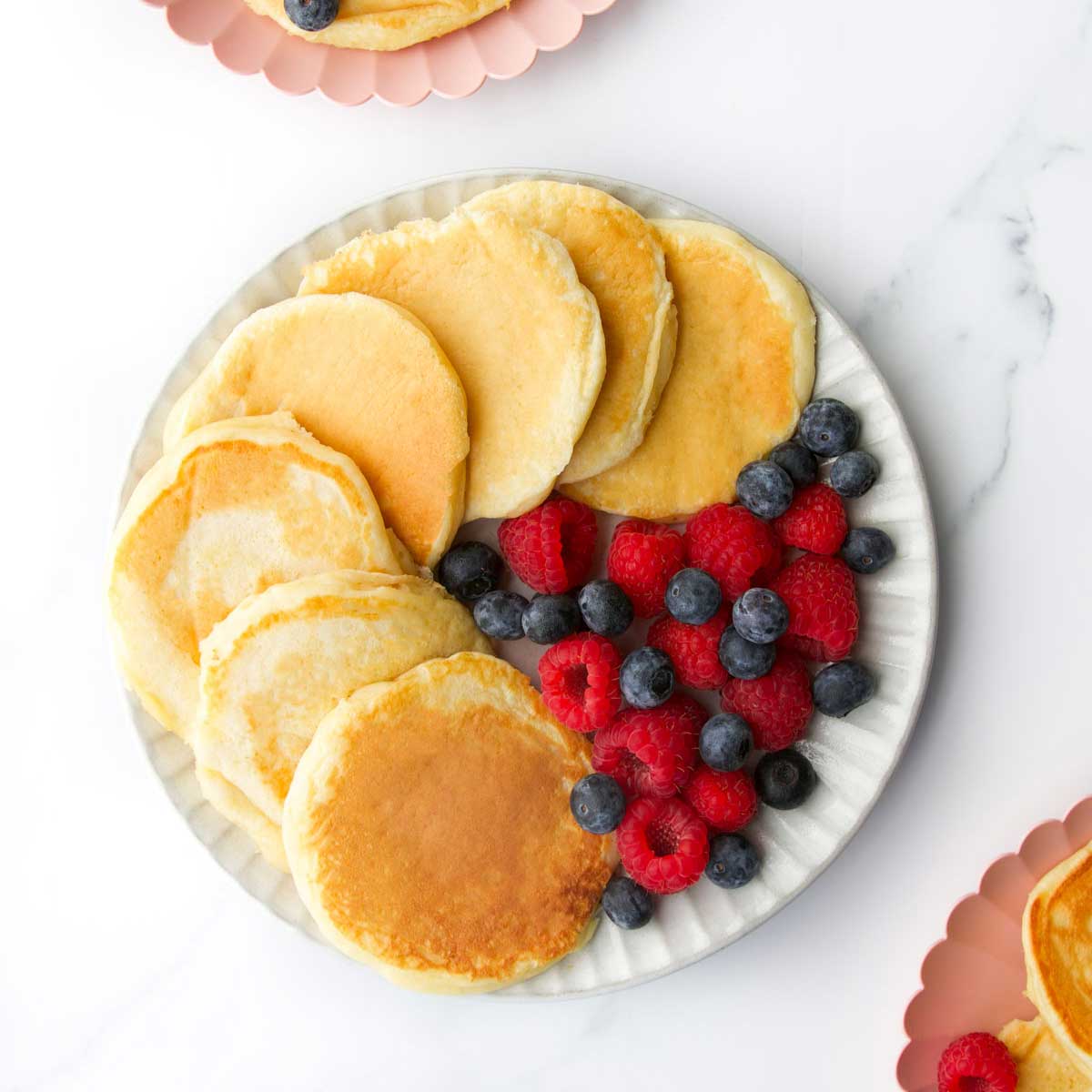 Yogurt Pancakes On Plate With Side of Fresh Berries.