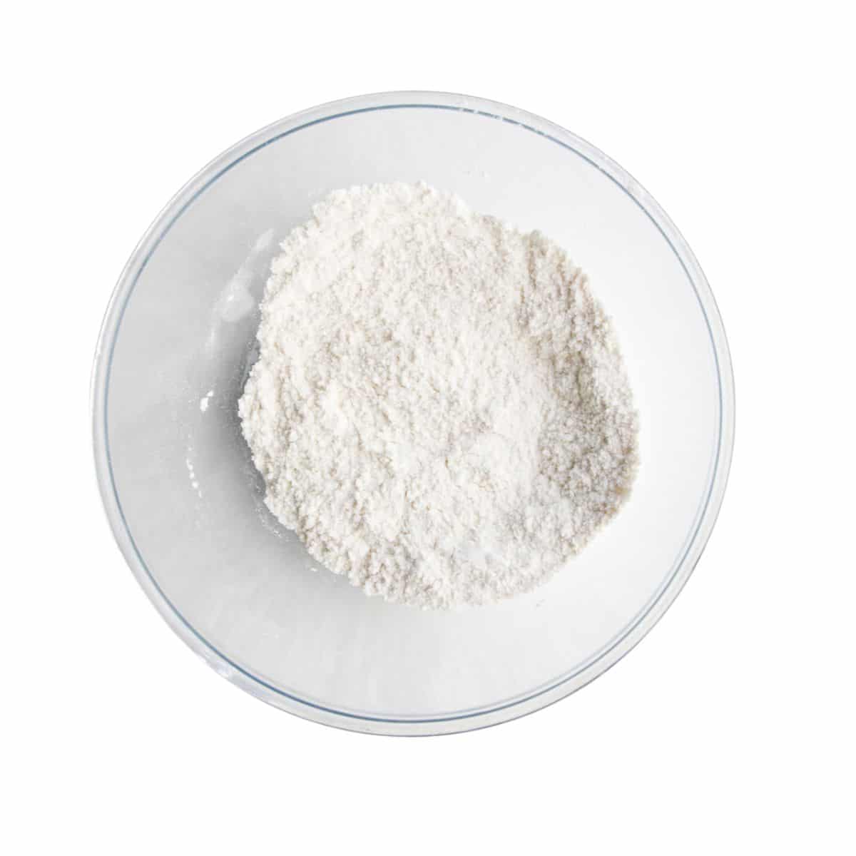 Flour, Baking Powder and Baking Soda Mixed Together in Glass Bowl.