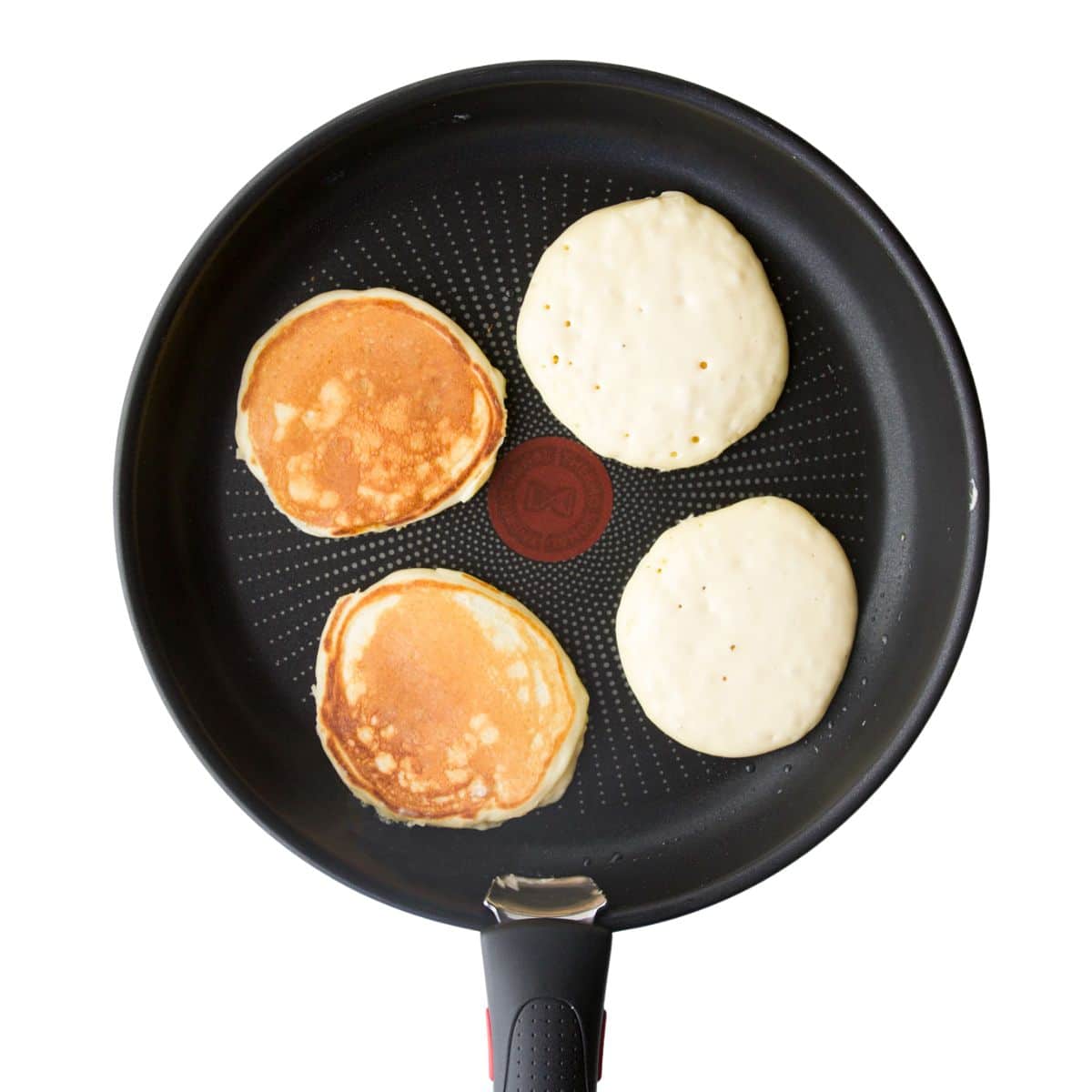 Pancakes in Pan, 2 Flipped and 2 Still to Be Flipped.