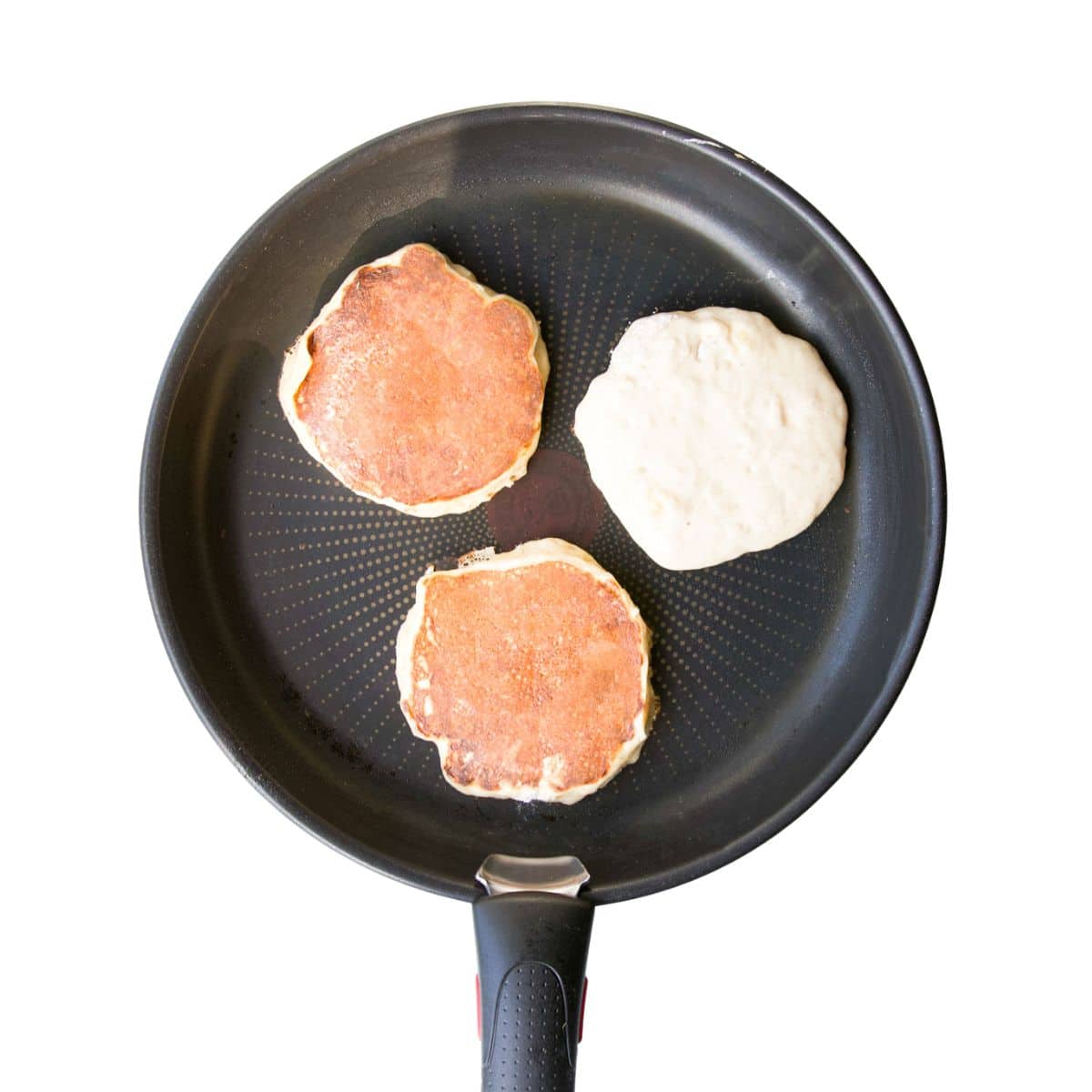 Banana Pancakes in Skillet. Two flipped and One Before Flipping.